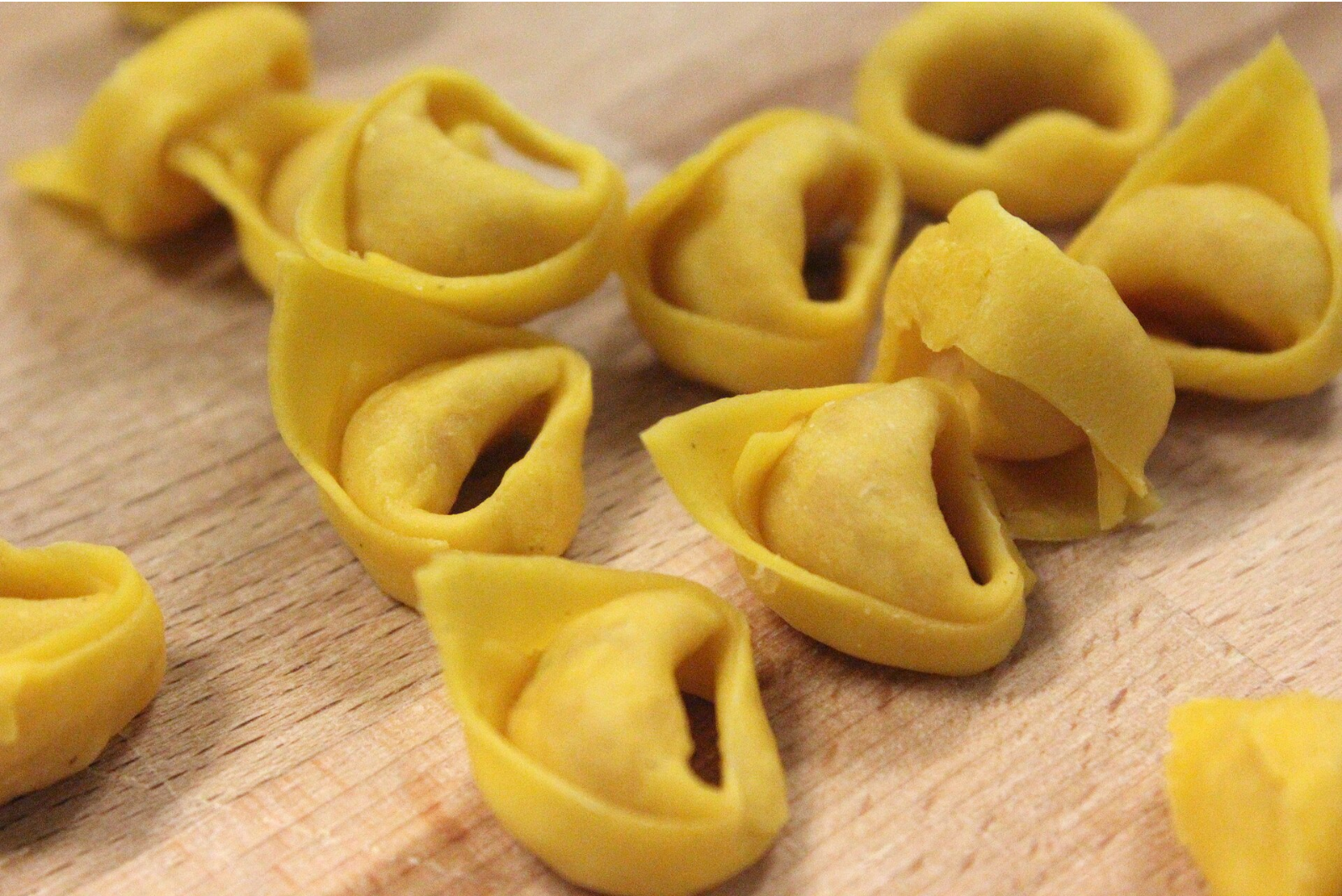 Wikipedia's Tortellini article showing a photo of hand-folded tortellini pasta arranged on a floured surface