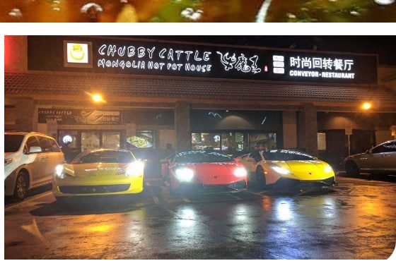 The storefront of Chubby Cattle Mongolia Hot Pot House at night, with three exotic sports cars parked outside on Spring Mountain Road area in Las Vegas