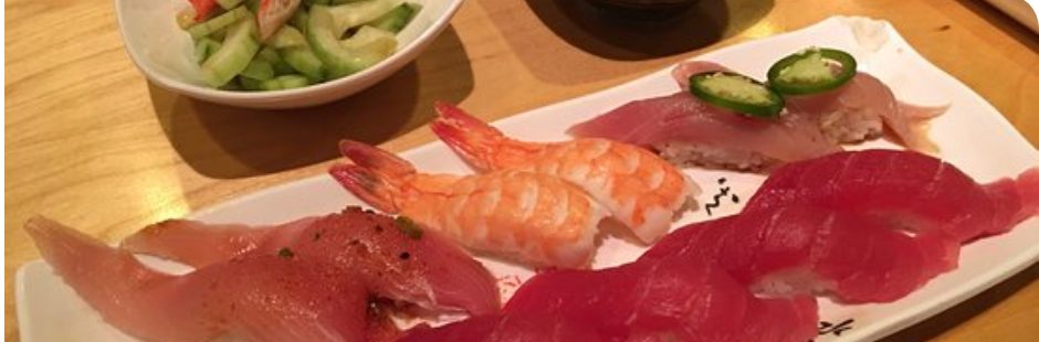 A sashimi platter of shrimp, salmon, yellowtail, and tuna nigiri at an all-you-can-eat sushi restaurant on Spring Mountain Road in Las Vegas