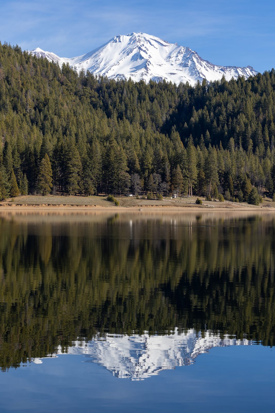 Mount Shasta, a snow-covered stratovolcano in the Cascade Range, seen across Lake Siskiyou in Northern California