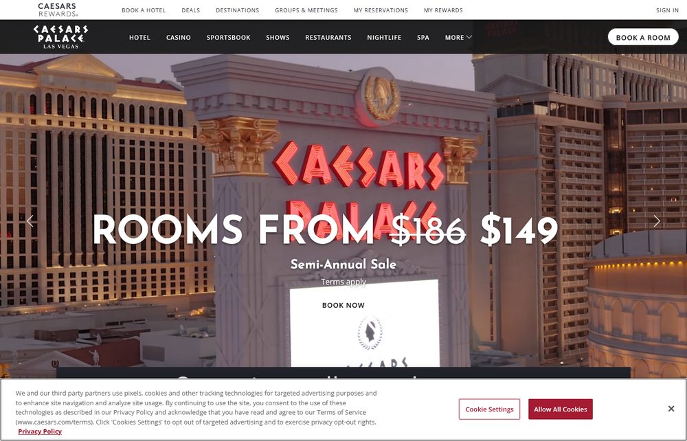Caesars Palace's own homepage, showing its illuminated red Caesars Palace signage on the resort's Roman-columned facade at dusk