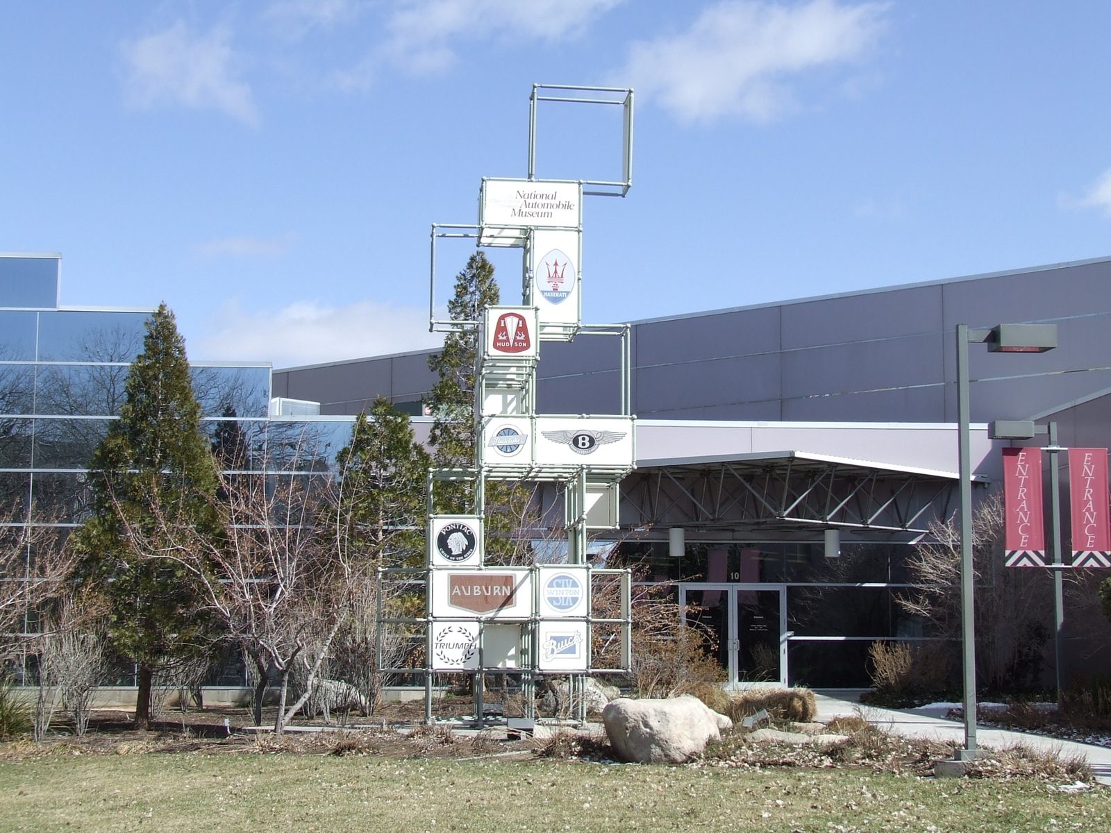 The exterior of the National Automobile Museum in downtown Reno, Nevada, a modern building with large glass windows near the Truckee River