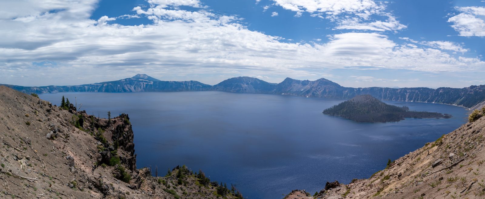 Crater Lake National Park in Oregon, showing the lake's deep blue water surrounded by the steep caldera rim