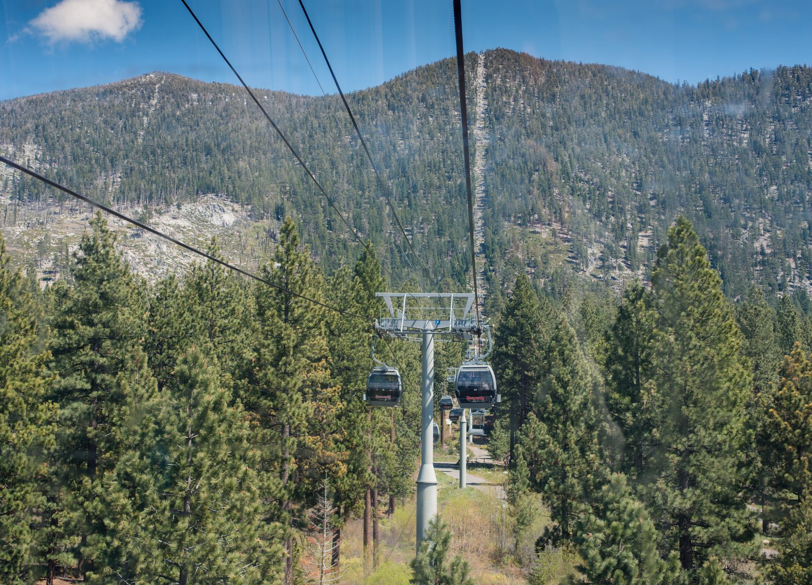 The Heavenly Gondola base terminal in South Lake Tahoe, with a gondola cabin departing the station toward the mountain