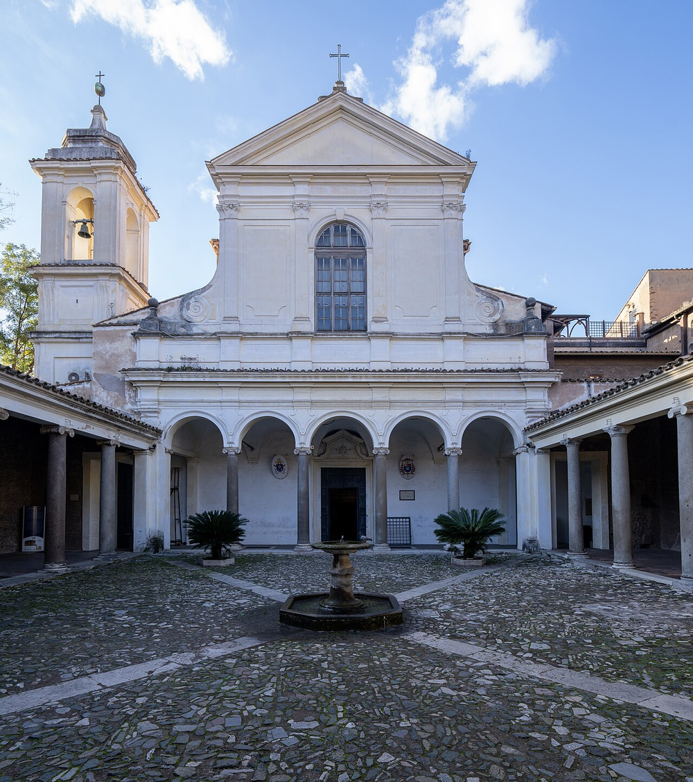Wikipedia's San Clemente, Rome article showing a photo of the basilica's courtyard and facade, with the twelfth-century church that sits above two older buried levels