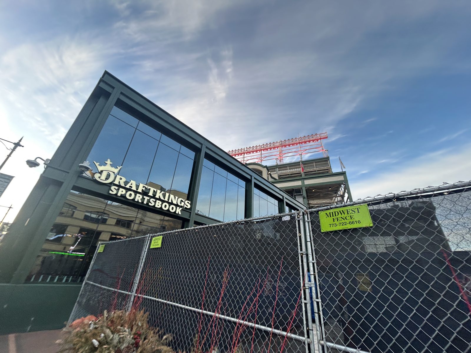 A DraftKings Sportsbook retail location under construction outside Wrigley Field in Chicago, with the DraftKings Sportsbook sign visible on a glass-walled building