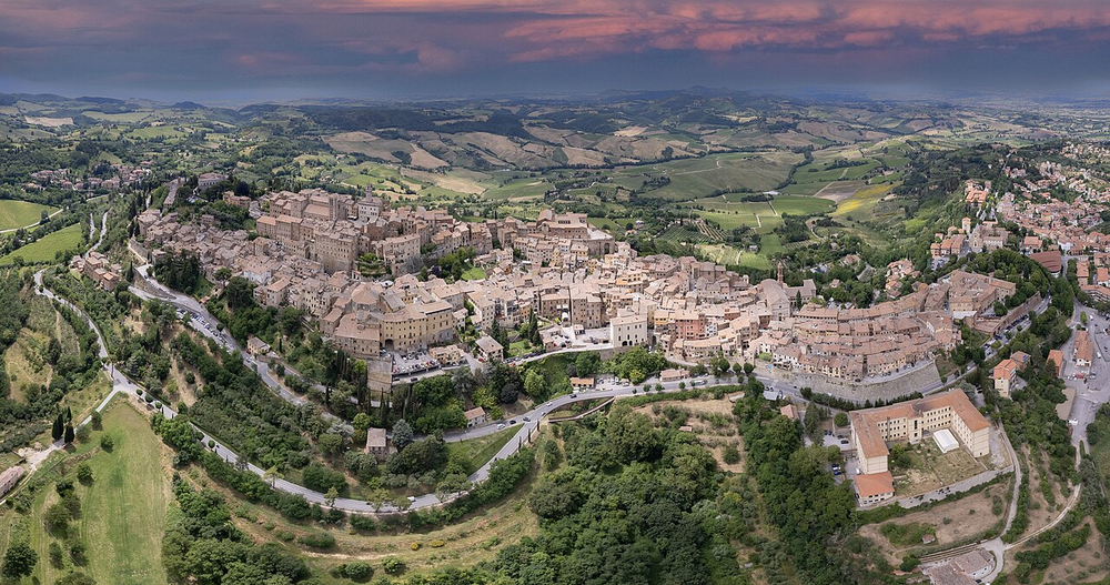 Wikipedia's Montepulciano article showing an aerial photo of the hilltop wine town on its limestone ridge, surrounded by vineyards