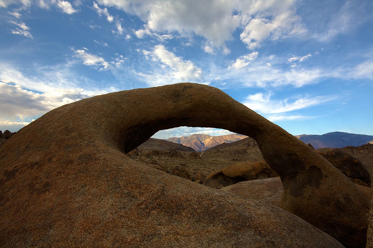 Mobius Arch in the Alabama Hills near Lone Pine, California, framing the snow-capped peak of Mount Whitney in the distance