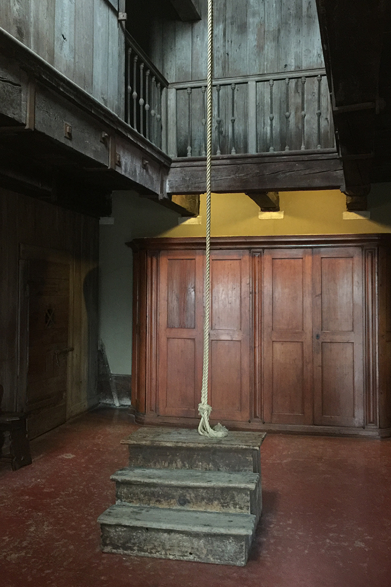 The Doge's Palace official visiting page for the Secret Itineraries Tour, showing the torture chamber with its wood-beamed mezzanine and a rope hoist hanging above a wooden step stool