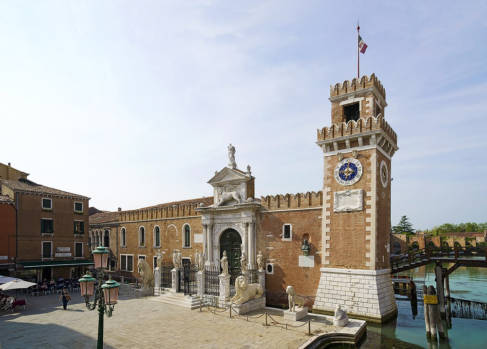 Wikipedia's Venetian Arsenal article showing a photo of the complex's main gate, the Porta Magna, flanked by two crenellated brick towers