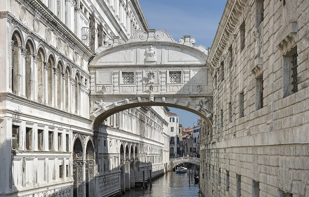 Wikipedia's Bridge of Sighs article showing a photo of the enclosed white limestone bridge spanning a narrow canal between the Doge's Palace and the New Prison