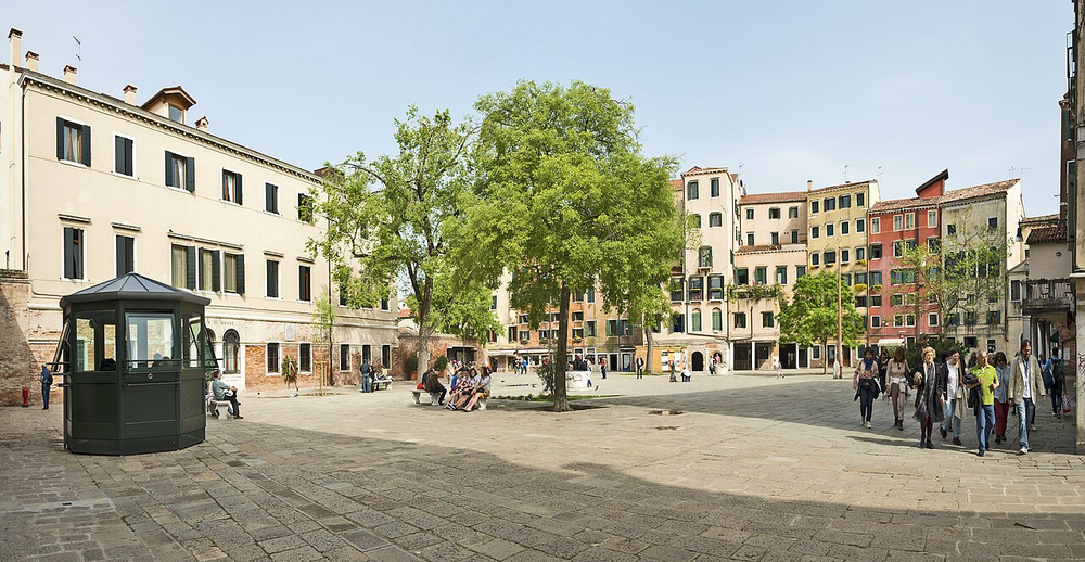 Wikipedia's Venetian Ghetto article showing a photo of the main square, lined with tall residential buildings, where Jewish residents of Venice were required to live starting in 1516